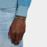  Man wearing sterling silver malachite rectangular station tennis bracelet at wrist showing continuous deep forest green malachite stone face with vivid emerald banding by Jan Leslie