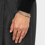 Man wearing oxidized sterling silver double-strand Balinese foxtail chain bracelet on wrist close-up showing chain texture and barrel end cap detail by Jan Leslie