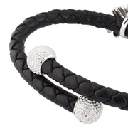 "Black double-strand braided leather bypass cuff bracelet with two pavé crystal golf ball end caps and black enamel golf bag clasp with silver golf club detail