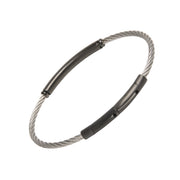 Two-tone twisted cable bracelet with a single black PVD tube bar station, highlighting the secure push-clasp closure.
