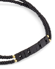 Double-strand matte black heishi bead bracelet close-up showing gold vermeil accent bead stations and rectangular bar centerpiece by Jan Leslie