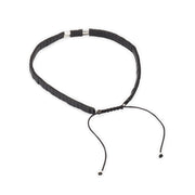 Matte black heishi bead bracelet with sterling silver tube spacers and adjustable black cord closure, Jan Leslie