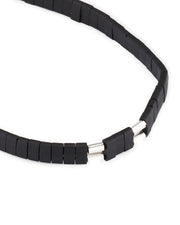 Close-up of matte black rubber heishi disc bead bracelet with silver cylindrical magnetic clasp detail