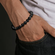 a matte black onyx beaded bracelet with sterling silver rondelle accents.