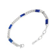 Sterling silver curb chain bracelet with inlaid lapis lazuli rectangular stations and an adjustable lobster clasp closure.