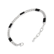 Sterling silver curb chain bracelet with inlaid black onyx rectangular stations and an adjustable lobster clasp.