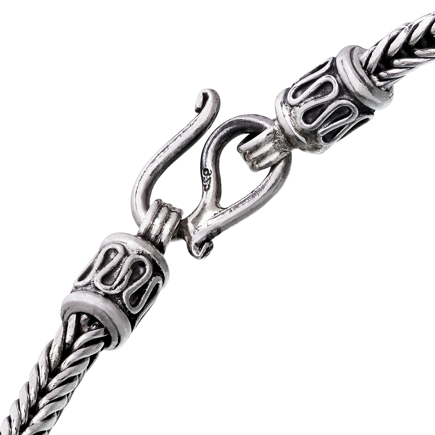Close-up of oxidized sterling silver braided wheat chain bracelet showing decorative end caps and hook clasp with 925 hallmark by Jan Leslie.