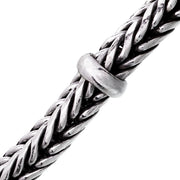 Close-up of oxidized sterling silver heavy braided wheat chain bracelet with smooth ring accent by Jan Leslie.