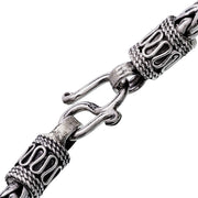 Close-up of oxidized sterling silver wide braided wheat chain bracelet showing rope-wrapped end caps and hook clasp with 925 hallmark by Jan Leslie.