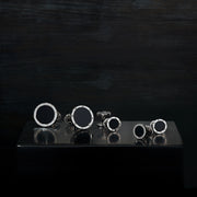 Black onyx round screw-motif cufflinks and tuxedo stud set displayed on dark reflective tray — Jan Leslie