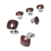 Sterling silver cushion-cut faceted ruby tuxedo stud and cufflink set with bezel settings and swivel toggle backings.