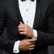 Man in black tuxedo wearing rainbow gummy bear enamel cufflinks and matching tuxedo studs on white dress shirt.