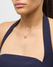 Model in navy halter dress wearing multicolor enamel open circle gold necklace — Jan Leslie