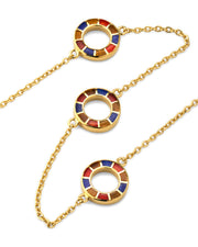 Close-up of multicolor enamel segmented circle station necklace pendants in gold — Jan Leslie