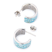Sterling silver blue enamel petal Seed of Life cutwork wide huggie hoop earrings pair angled view showing powder blue enamel ground silver Seed of Life cutwork lattice engraved inner barrel and post-and-butterfly backs by Jan Leslie