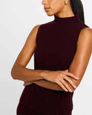 Woman in burgundy ribbed sleeveless mock-neck top wearing gold vermeil sterling silver wide-band white mother of pearl floral lattice huggie hoop earring, Jan Leslie