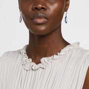 Model wearing sterling silver teardrop blue chalcedony and cobalt enamel drop earrings by Jan Leslie.