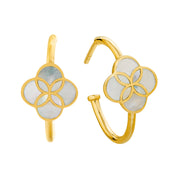 Pair of gold huggie hoop earrings with quatrefoil clover-shaped white mother of pearl inlay and gold petal overlay, showing front and side profile views