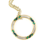 Gold-plated open circle pendant necklace with alternating white mother-of-pearl and teal enamel diamond inlay segments on a delicate curb chain.