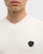  Model wearing clear crystal sculpted flower lapel pin on cream knit sweater vest full torso view by Jan Leslie.