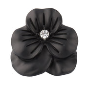 Clear crystal sculpted flower lapel pin front view showing full petal silhouette and faceted crystal center by Jan Leslie.