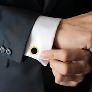 Yellow gold black onyx and cubic zirconia halo cufflinks styled on white French cuff with charcoal suit, Jan Leslie