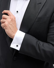 Man wearing sterling silver black onyx and crystal pavé tuxedo set showing crystal pavé halo shirt studs on placket and cufflinks at wrist with black tuxedo and bow tie by Jan Leslie