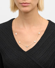Model in wearing white mother-of-pearl five-heart station gold necklace — Jan Leslie