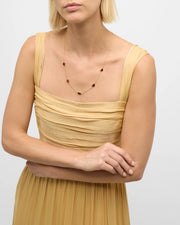 Model in gold dress wearing red tiger's eye five-heart station gold necklace — Jan Leslie