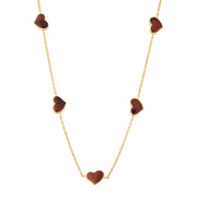 "Red tiger's eye five-heart station necklace draped on gold cable chain — Jan Leslie