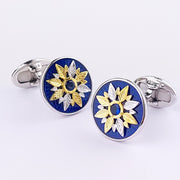 Round sterling silver cufflinks with cobalt blue enamel, gold vermeil sunflower motif, and blue sapphire crystal center. Jan Leslie