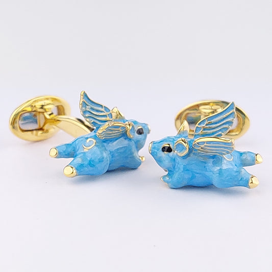 Hand-enamelled flying pig cufflinks in gold vermeil. Sky blue with black crystal eyes and feathered wings. Jan Leslie.