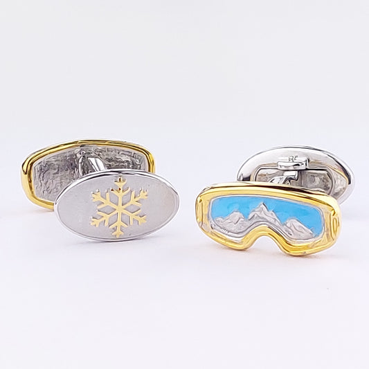 Mismatched ski goggle and snowflake sterling silver cufflinks with blue enamel, mountain relief, and gold vermeil detail. Jan Leslie