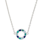 Woman in black crew neck top wearing a sterling silver three-station necklace with open circle blue and teal enamel mosaic pendants.