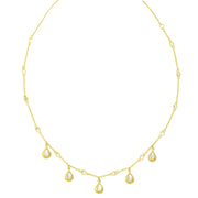 Delicate gold chain necklace featuring dangling teardrop charms and bezel-set mother-of-pearl stations 