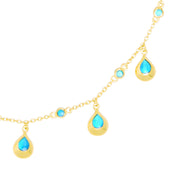 Gold chain necklace with vibrant turquoise teardrop charms and bezel-set stone stations 