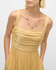 Model in tan dress wearing green malachite five-heart station gold necklace — Jan Leslie