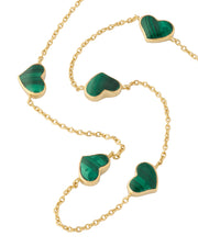 Green malachite five-heart bezel station necklace draped on gold cable chain — Jan Leslie