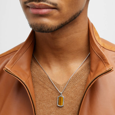 Close up of a male model wearing the Tiger's Eye Gemstone Plaque Sterling Silver Pendant Necklace. 