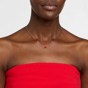  Model wearing gold vermeil four-station rectangular carnelian necklace on red strapless top by Jan Leslie.
