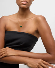 Model wearing gold vermeil malachite heart pendant necklace on delicate cable chain with black strapless top full torso view by Jan Leslie.