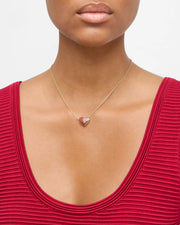 Model wearing gold vermeil pink mother-of-pearl heart pendant necklace on delicate cable chain with red ribbed top by Jan Leslie.