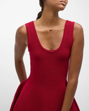 Model wearing gold vermeil red tiger's eye heart pendant necklace on delicate cable chain with red ribbed dress by Jan Leslie.