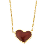 Gold cable chain necklace with a large heart-shaped pendant featuring deep red tiger's eye stone in a gold bezel setting.