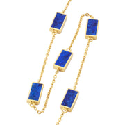 Gold cable chain station necklace with five rectangular lapis lazuli stones in gold bezel settings.