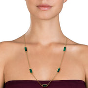 Woman wearing gold vermeil sterling silver five-station malachite rectangle long station necklace , showing banded green stone bezel settings on delicate cable chain, Jan Leslie luxury women's fine jewelry lifestyle.