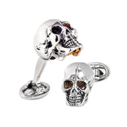 Pair of sterling silver 3D skull cufflinks with gold-accented eye sockets and teeth detail, shown closed and open revealing gold brain interior, with oval swivel backs