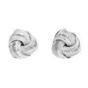 Sterling silver ribbed love knot stud earrings with rope-textured interlocking swirl design and butterfly back.