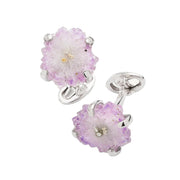 Angled view of sterling silver raw amethyst stalactite slice geode cufflinks in six-prong setting showing crystal cluster texture and oval swivel back closure, luxury men's fine jewelry.