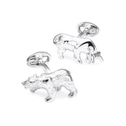 Staggered pair of sterling silver three-dimensional Wall Street bull and bear cufflinks with textured matte silver bear body and polished silver bull body, showing silver oval swivel back closure, Jan Leslie